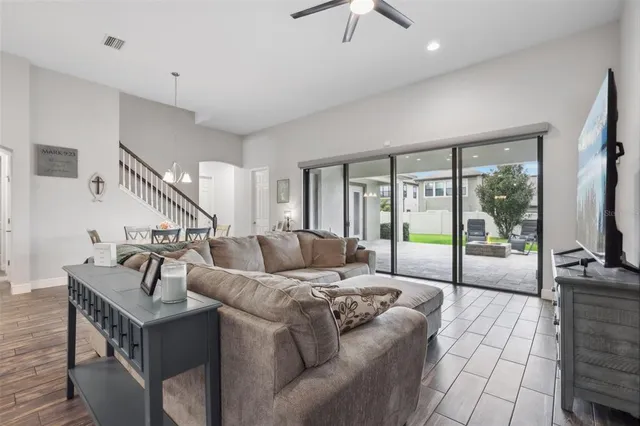 a living room with furniture and a floor to ceiling window