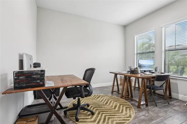 a view of a workspace with furniture and window