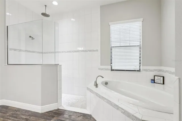 a bathroom with a bathtub and a window
