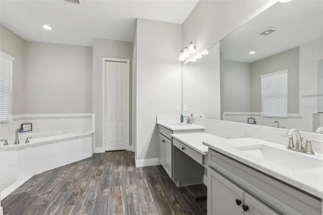 a bathroom with a granite countertop sink a toilet and shower