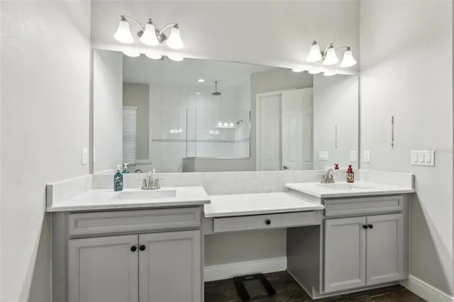 a bathroom with a sink double vanity and a mirror