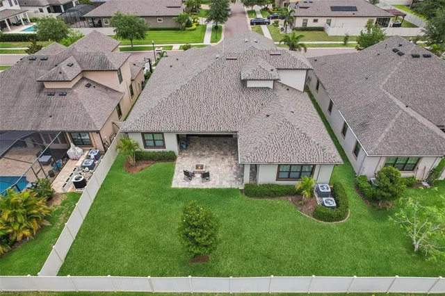an aerial view of a house with a yard