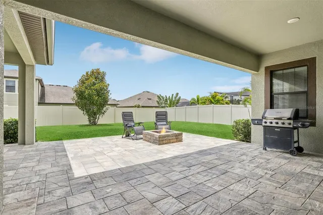 a view of a backyard with garden and patio
