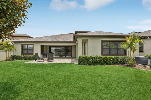 a front view of a house with a garden and patio