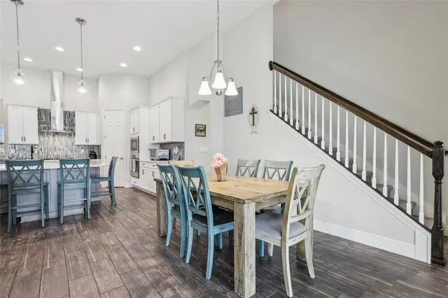 a dining room with furniture entryway and wooden floor