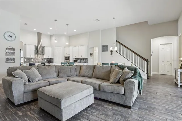 a living room with furniture and a wooden floor