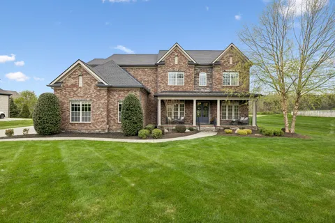a front view of a house with swimming pool and porch
