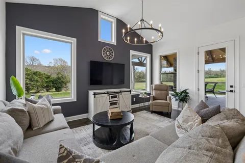 a living room with fireplace furniture and a flat screen tv
