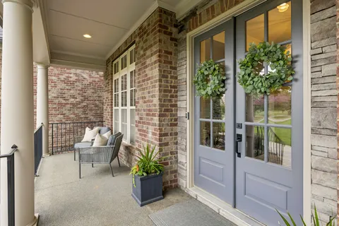 a kitchen with stainless steel appliances granite countertop a kitchen island a stove a table and chairs