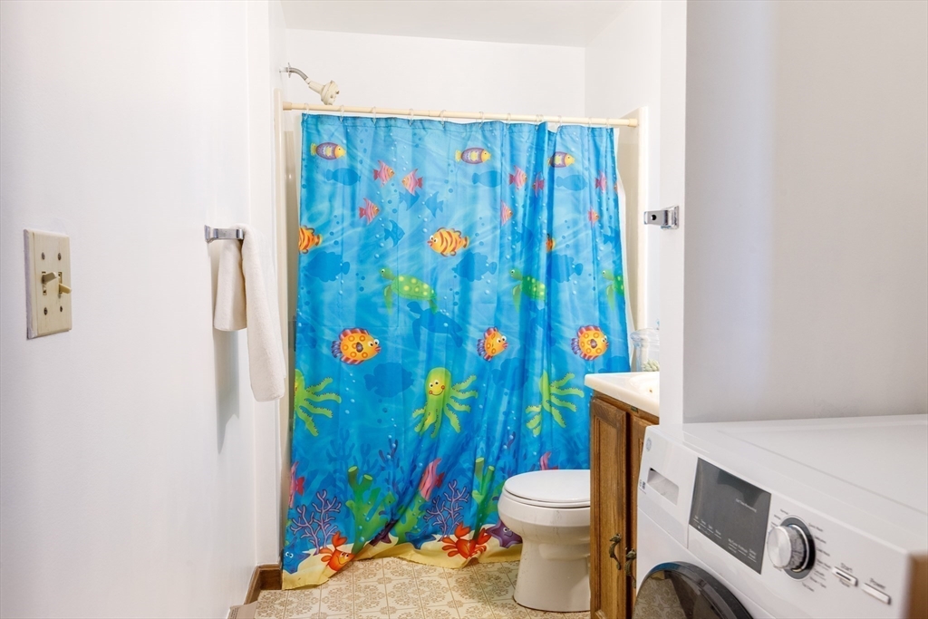 170 Perry Avenue, Unit 3A Worcester, MA 01610 - Photo 13 of 16 a bathroom with a toilet and shower curtain