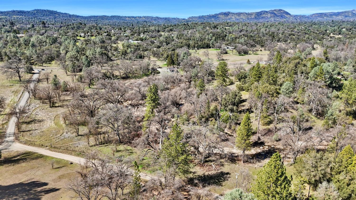 5128 Darrah Road Mariposa, CA 95338 - Photo 4 of 12 a view of a city with lush green forest