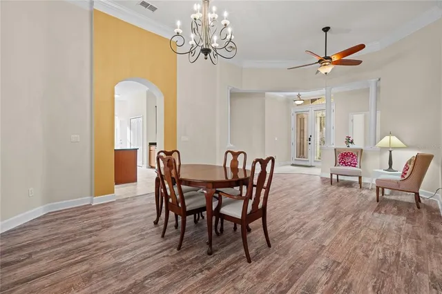 a view of a dining room with furniture wooden floor and chandelier