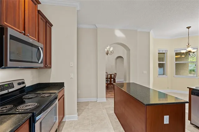 a kitchen with stainless steel appliances granite countertop a stove and a microwave