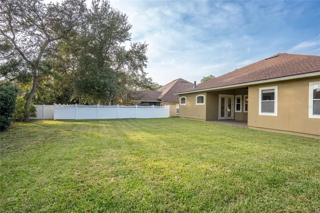 a view of a house with a backyard