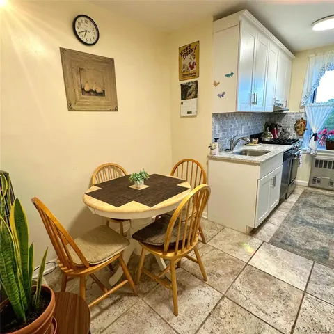 a kitchen with a table and a stove top oven