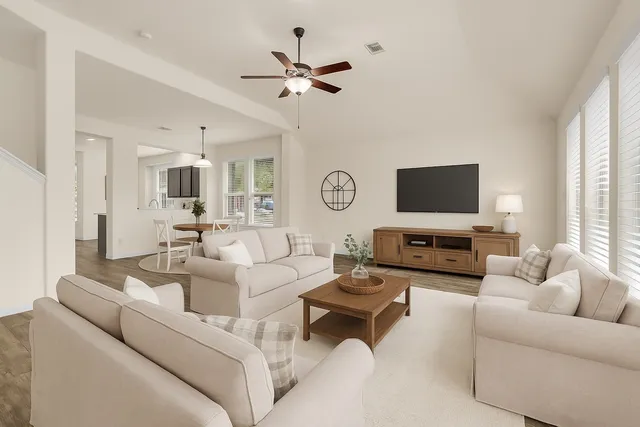 a living room with furniture a fireplace and a flat screen tv