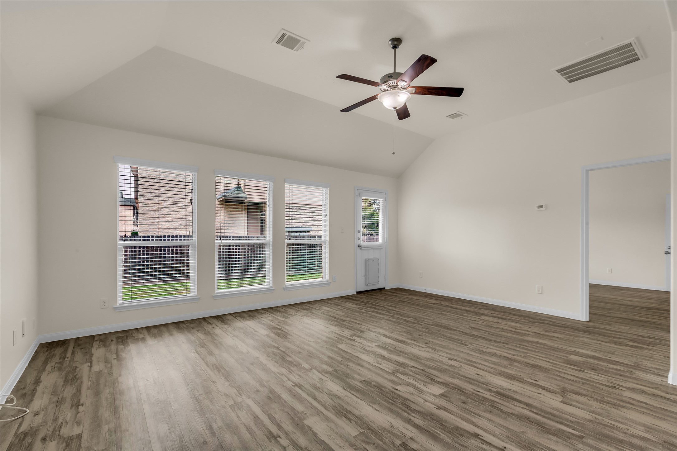 3807 Springcrest Lane Montgomery, TX 77356 - Photo 13 of 31 a view of an empty room with wooden floor and a window