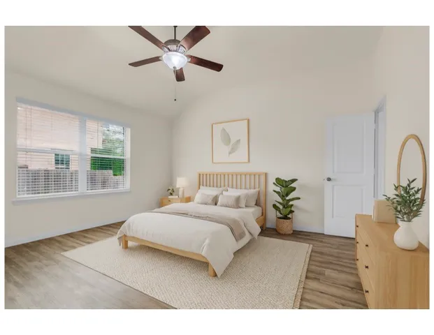 a bedroom with a large bed and a window