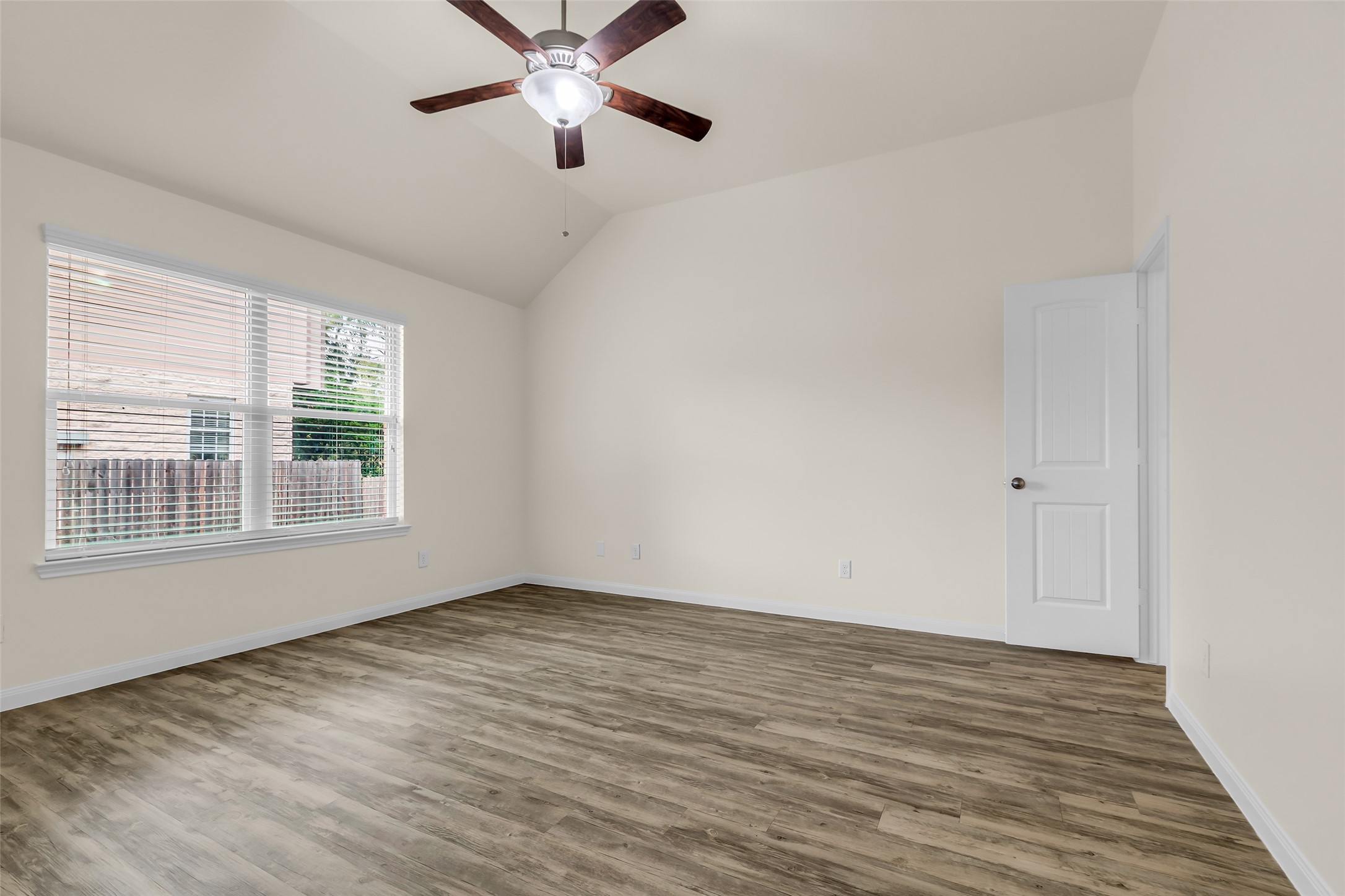3807 Springcrest Lane Montgomery, TX 77356 - Photo 19 of 31 a view of an empty room with wooden floor and a window
