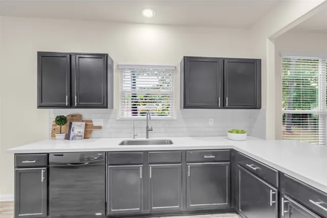 a kitchen with a sink and a window