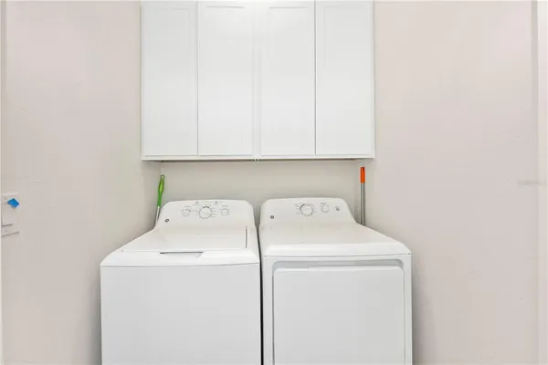 a swimming pool view with a seating space and a garden view