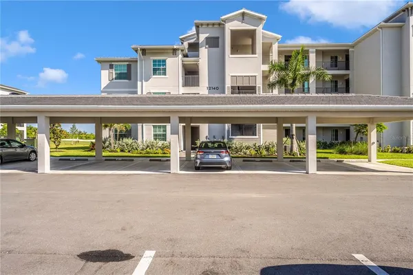 a front view of a house with glass windows and furniture