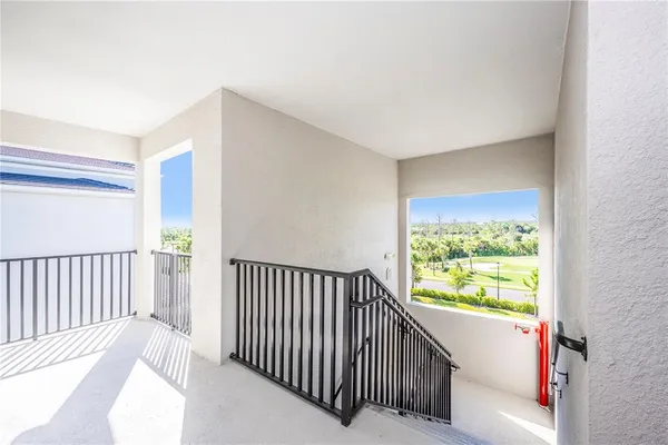 a view of a room with gym equipment and a large window