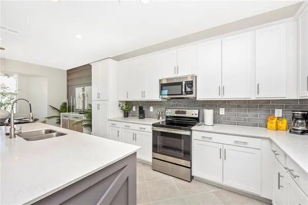 a dining room with furniture potted plants and wooden floor