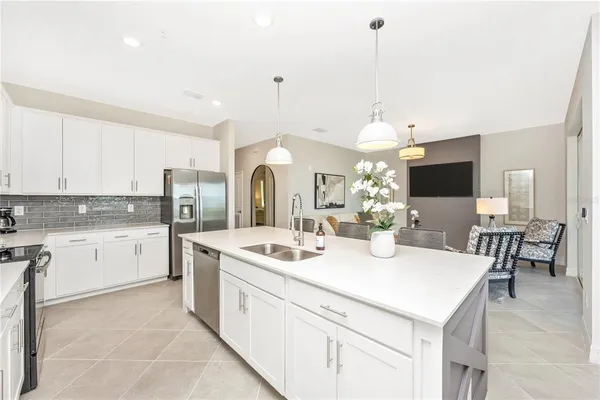 a kitchen with a dining table and chairs in it