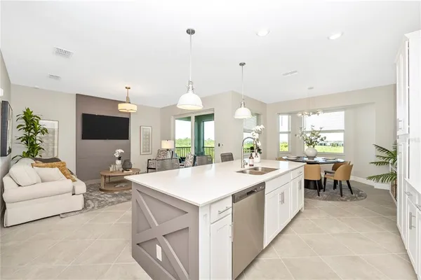 a living room with furniture a dining table and a flat screen tv