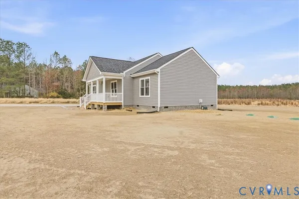 a view of a house with a yard and a large tree