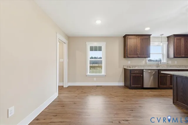 a view of kitchen with granite countertop window and a sink