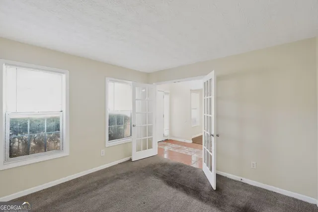 a view of room with window and hallway