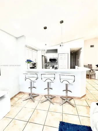 a living room with granite countertop kitchen island furniture and kitchen view