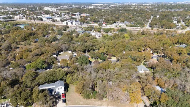 an aerial view of residential houses with city view