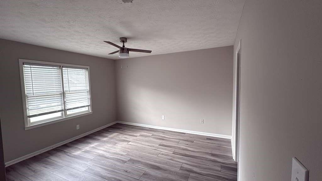 136 Hudson Bridge Terrace Stockbridge, GA 30281 - Photo 4 of 7 wooden floor in an empty room with a window