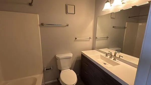a bathroom with a sink toilet and vanity