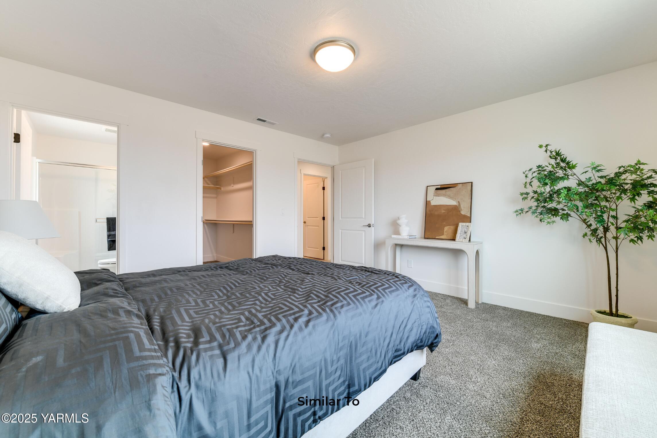 604 Vineyard Street, Unit PHASE 2 LOT 13) SPEC Grandview, WA 98930 - Photo 15 of 19 a bedroom with a bed and a potted plant
