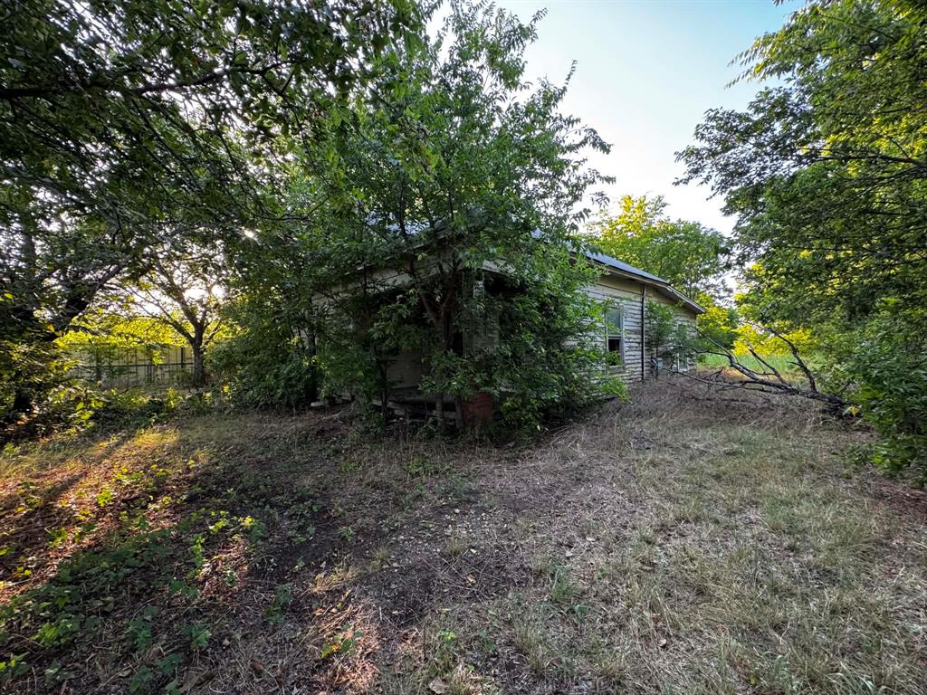 4270 Belz Road Sanger, TX 76266 - Photo 12 of 40 Rustic exterior structure, surrounded by dense natural foliage