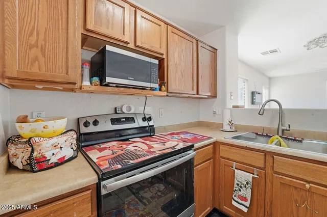 a kitchen with stainless steel appliances granite countertop a sink stove and cabinets