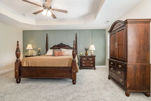 a bedroom with a bed dresser and a window