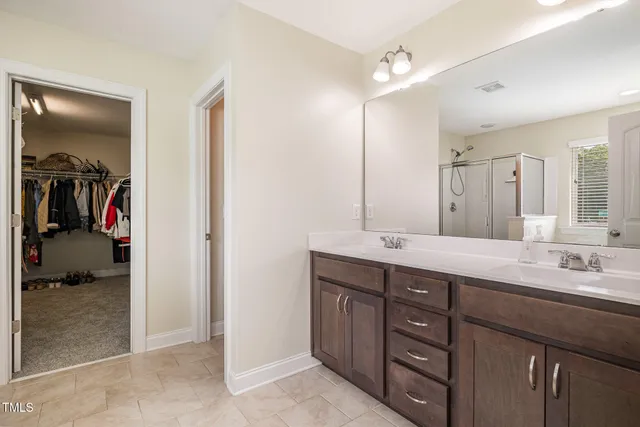 a bathroom with a double vanity sink and a mirror