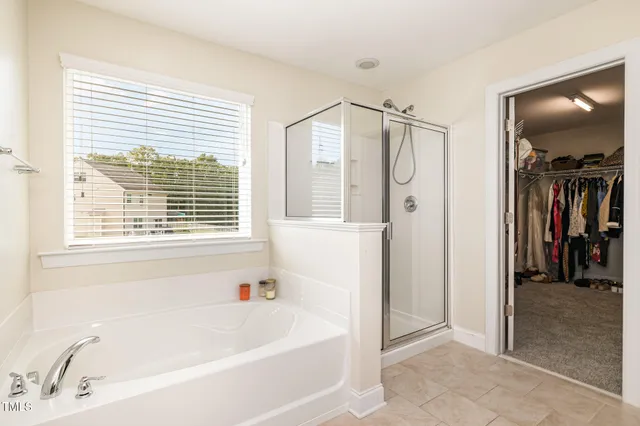 a bathroom with a bathtub and a shower