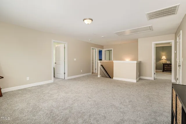 an empty room with closet and windows