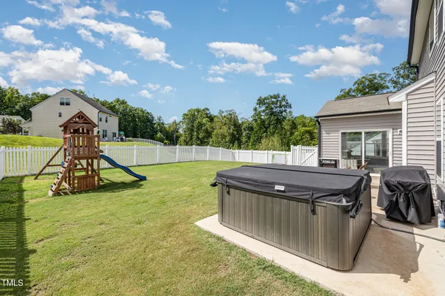 a view of a backyard with swimming pool