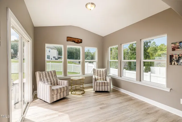 a living room with furniture and a large window with outer view