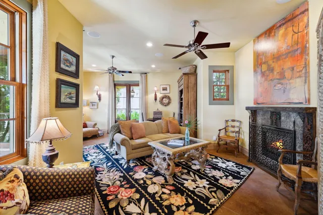 a dining hall with stainless steel appliances granite countertop a stove a sink a dining table and chairs with wooden floor