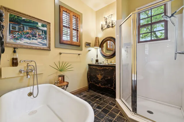 a bedroom with a large bed and ceiling fan