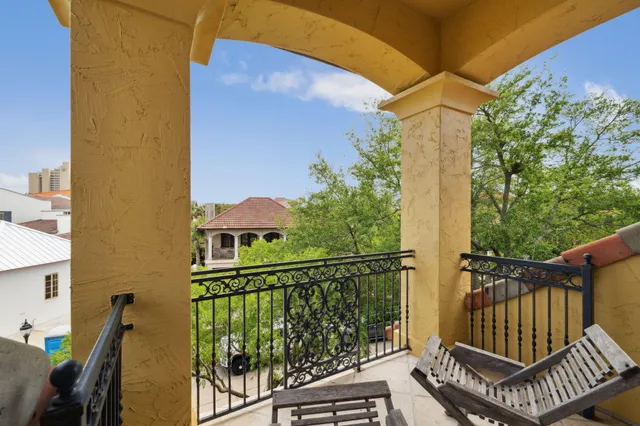 a view of pool with palm trees and plants