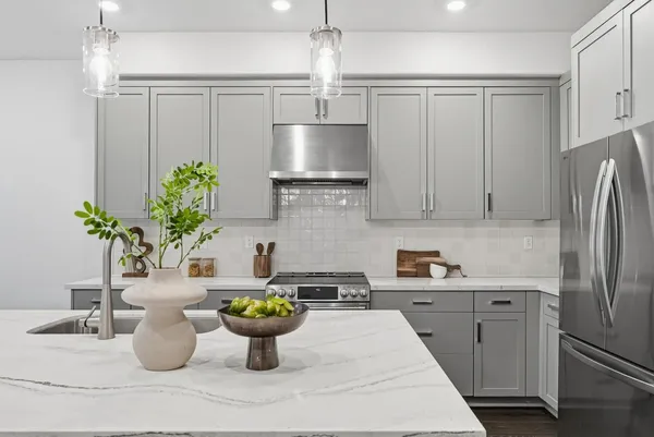 a kitchen with a refrigerator and a white table